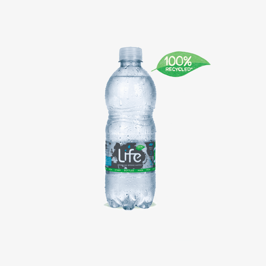 A plastic bottle of Life water with condensation droplets, labelled as 100% recycled, sits on a white background. A green leaf-shaped label beside the bottle reads “100% RECYCLED.”.