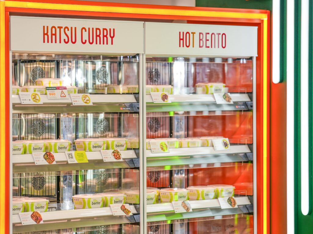 A brightly lit refrigerated display case labeled 