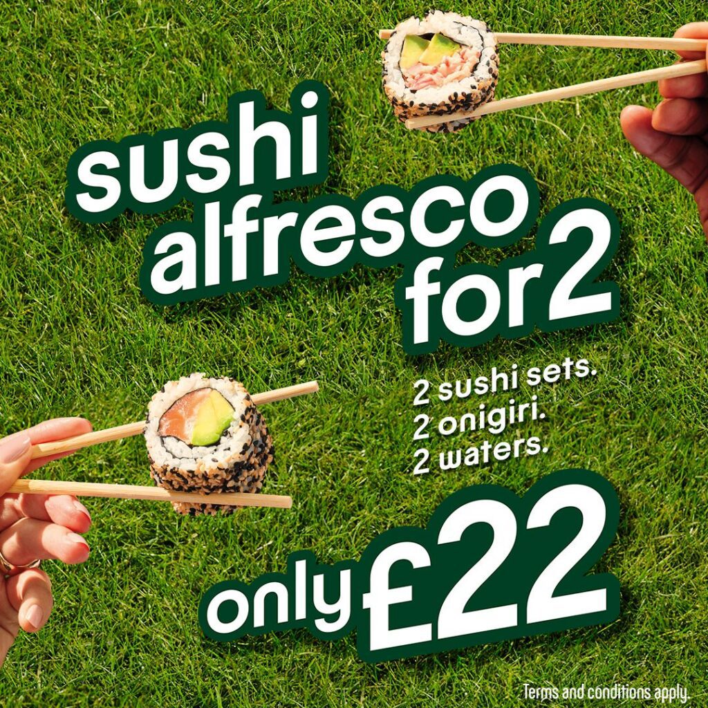 Two hands holding sushi with chopsticks over a grassy background. Text reads: 